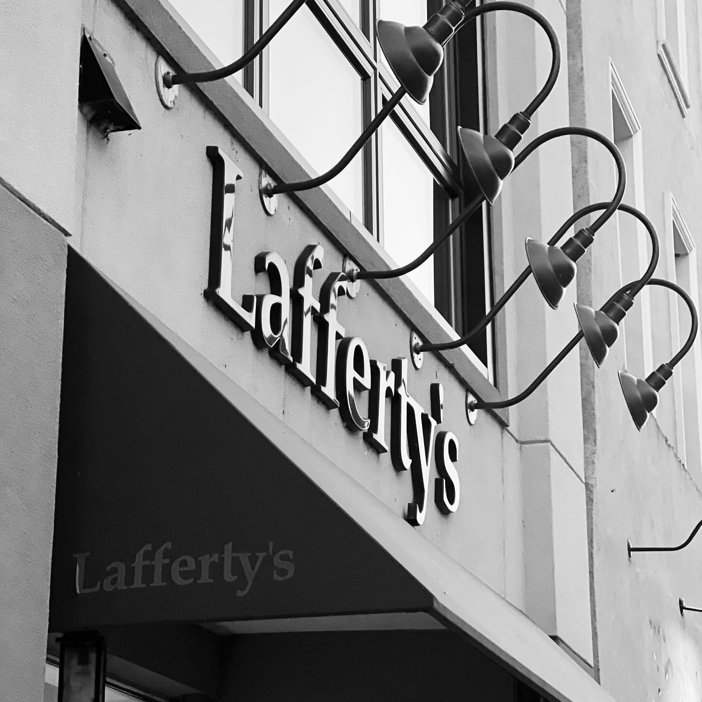 Lafferty's Menswear storefront sign with gooseneck lights